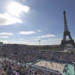 Crowd watching beach volleyball in front of the Eiffel Tower at the Olympics