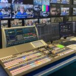 A control panel with multiple monitors showing For-a technology