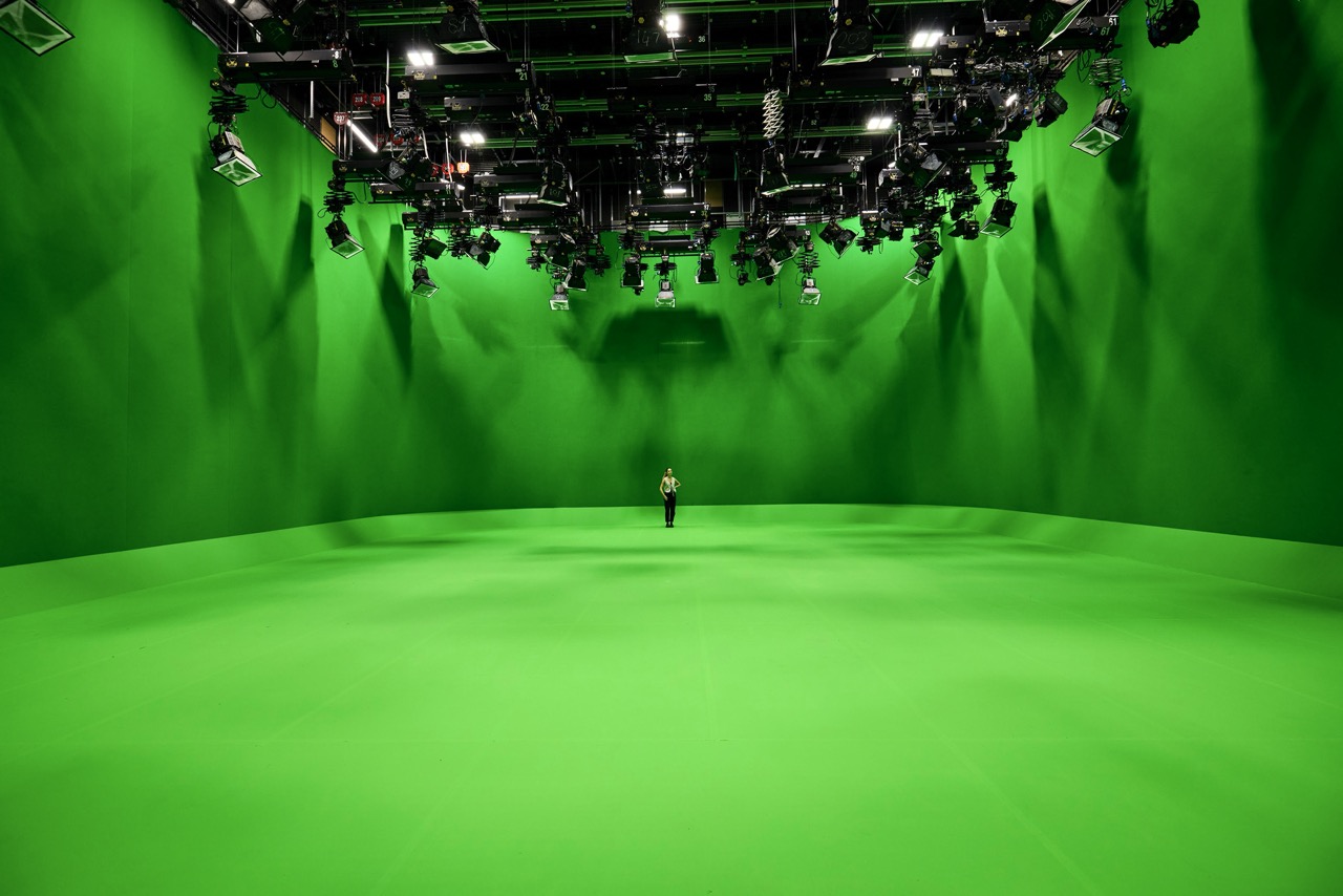 HQ3 green screen studio at Dock 10 MediaCityUK A vast green screen room with a person standing in the centre under lots of lights