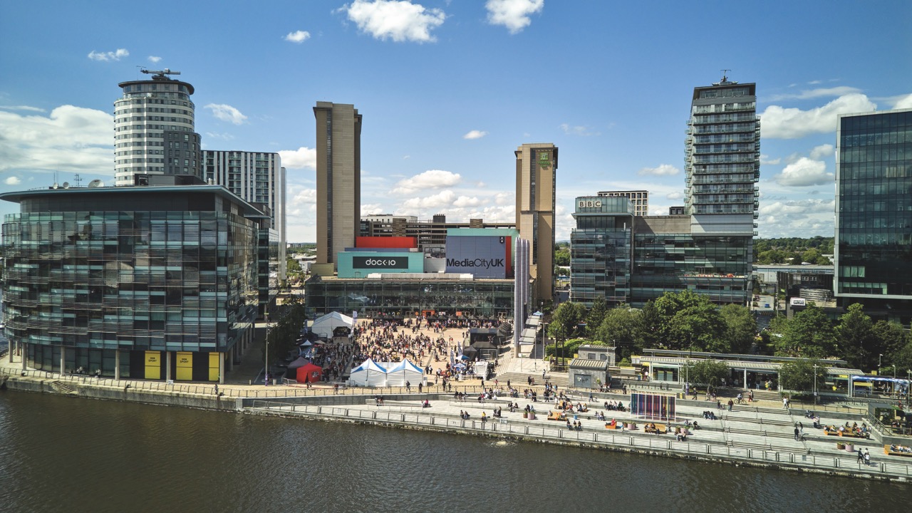 MWjun24-676409 Large A busy waterfront with steps leading up to modern buildings
