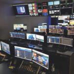A room full of computers both on desks and on walls