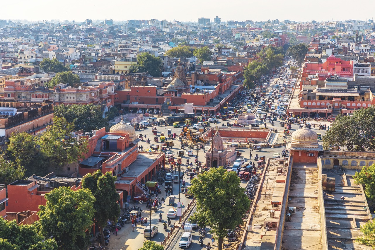 A broad view of a busy city with a main thoroughfare in India