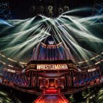 A stage through a fish-eye lens with lights and a sign saying WrestleMania