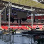 The interior of an empty Wembley Stadium with scaffolding and equipment from Sony set up