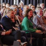 An audience sitting and watching a speaker at IBC2024 Conference